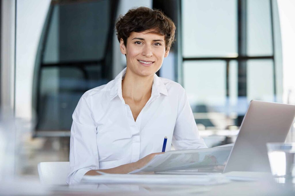 portrait-of-confident-businesswoman-sitting-at-des-2023-11-27-05-27-56-utc.jpg
